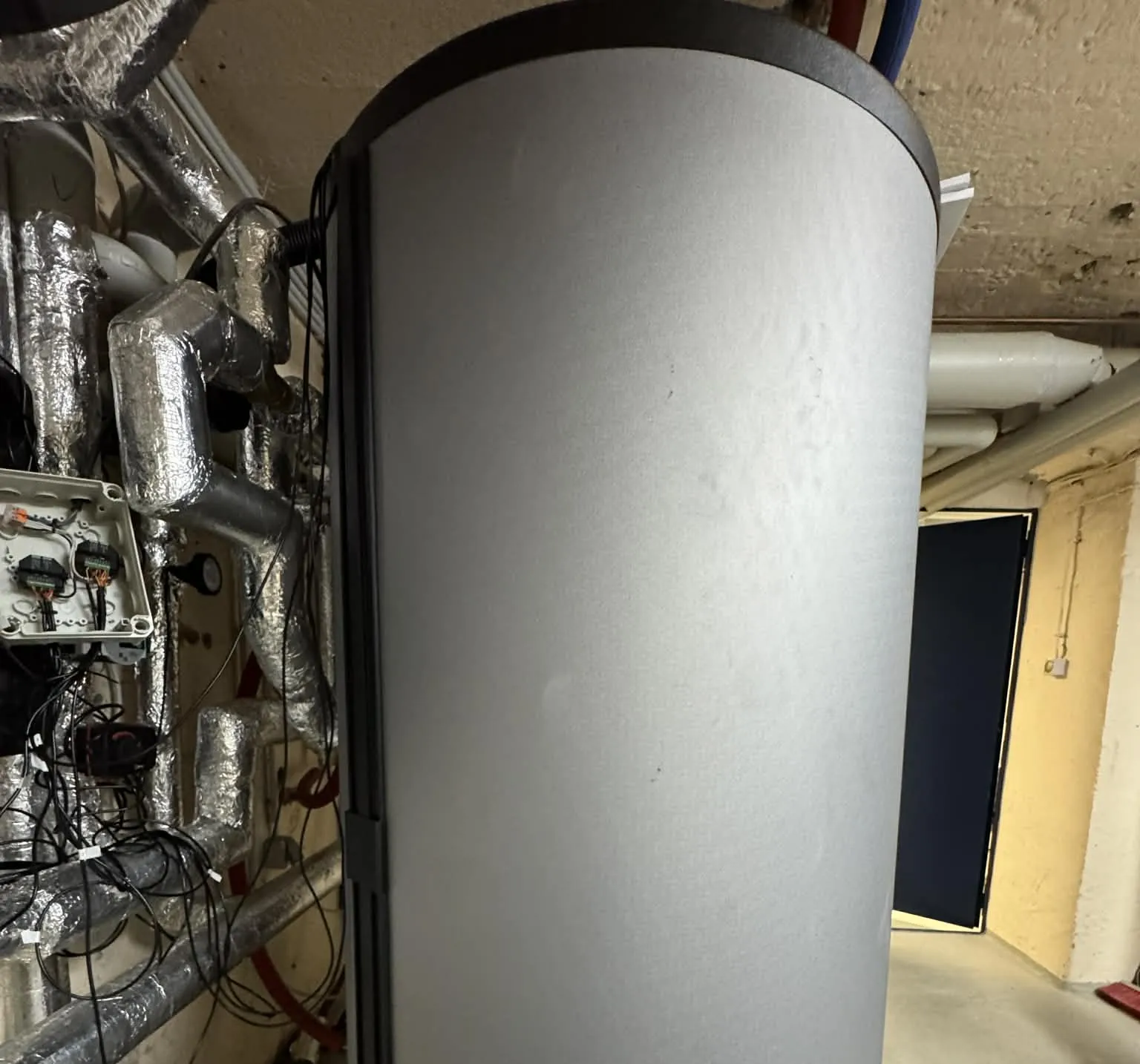 Basement mechanical room with installed heating and monitoring infrastructure